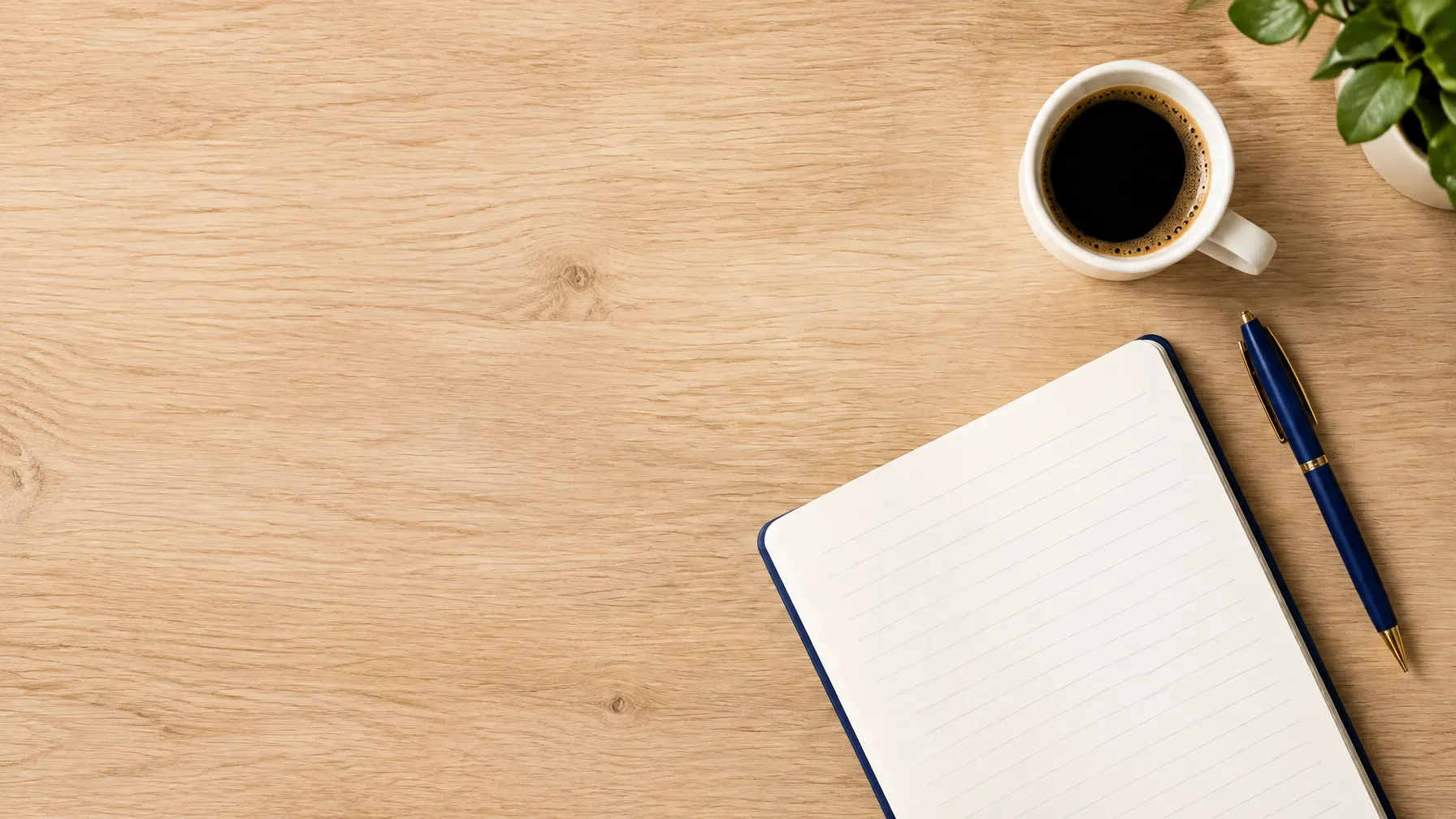 A quiet, welcoming desk surface with an open notebook and coffee
